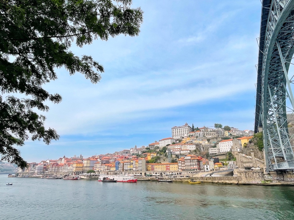 Photo of the city of Porto rising above the Duoro River, from across the Luis I Bridge.