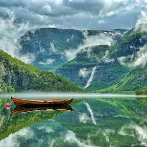 Picture of a lake with mountains and a row boat